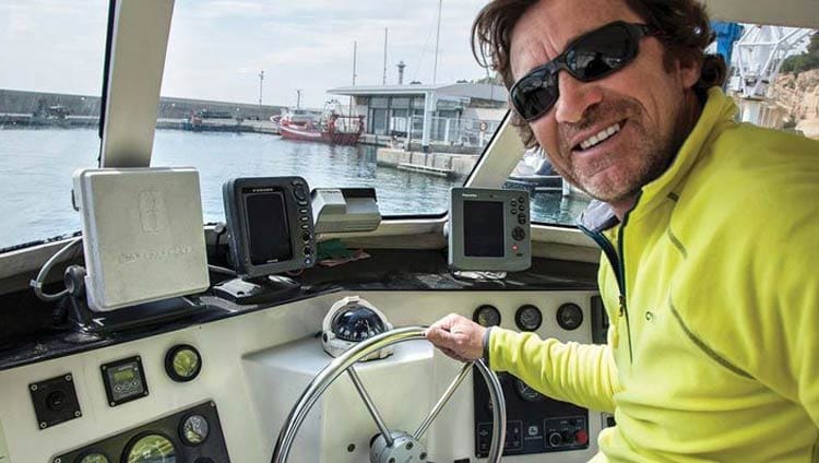 Miquel Rota, owner of M.Rota Diving, at the helm of ONAWA