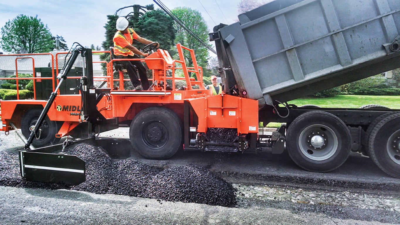 The Midland Machinery SPF-8 pushes a semi-truck as it unloads material into its hopper