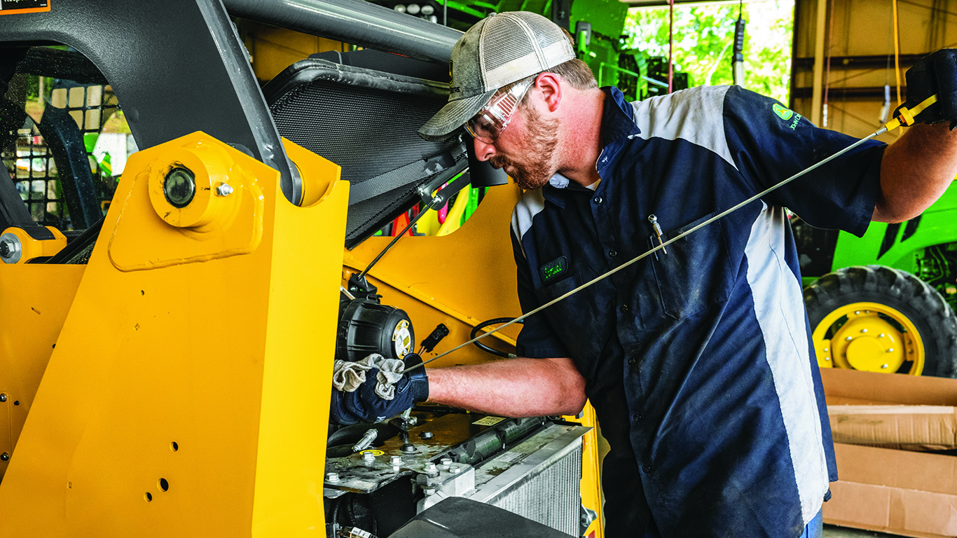 a man cleaning an engine part
