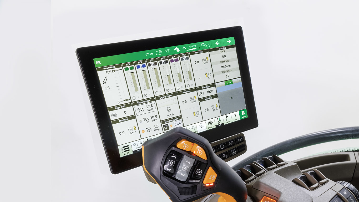 Close-up of tractor control panel with touchscreen showing settings, data, and control buttons.