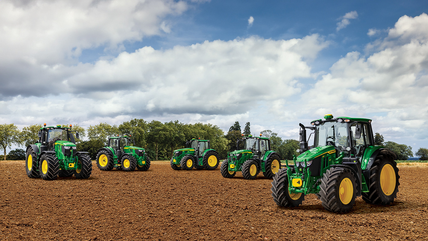 Tractors 6M Series 125 150 220 250 parked in a field Tractors 6M Series 125 150 220 250 parked in a field
