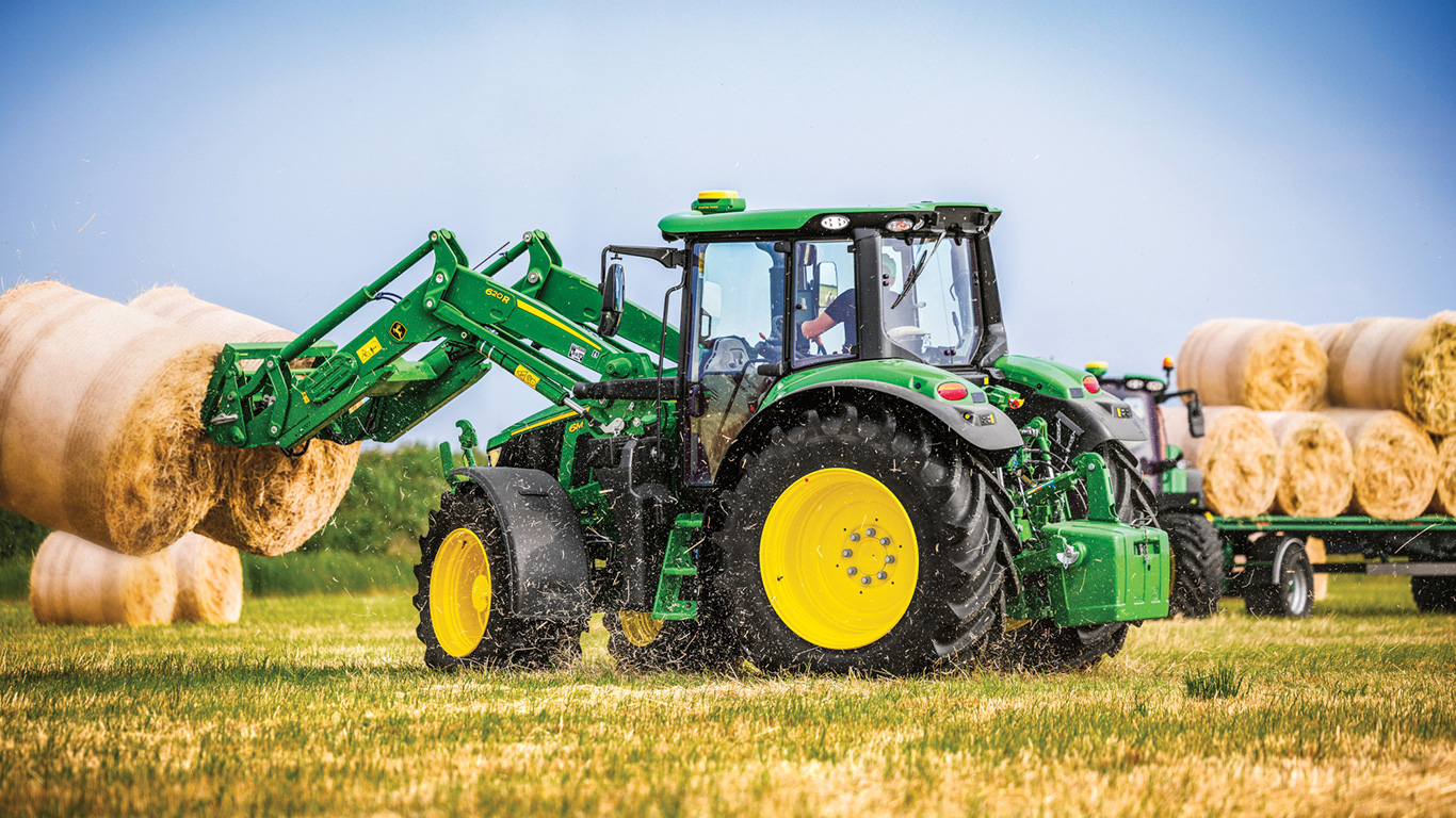 6M with loader picking up hay bales 6M with loader picking up hay bales