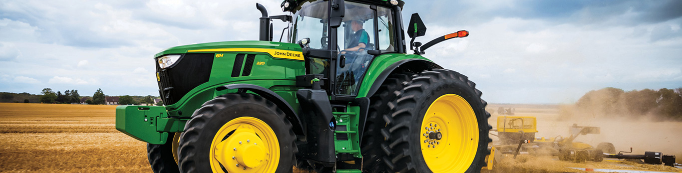 6M 220 tractor in a field