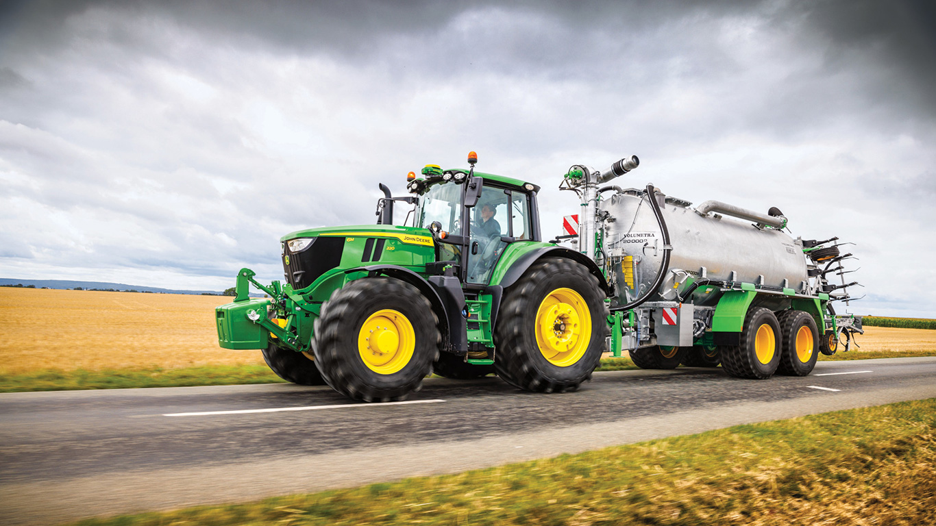 6M220 tractor with sprayer attached on a road 6M220 tractor with sprayer attached on a road