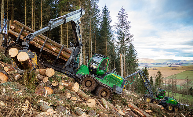 H Series forwarder on a hill surrounded by trees