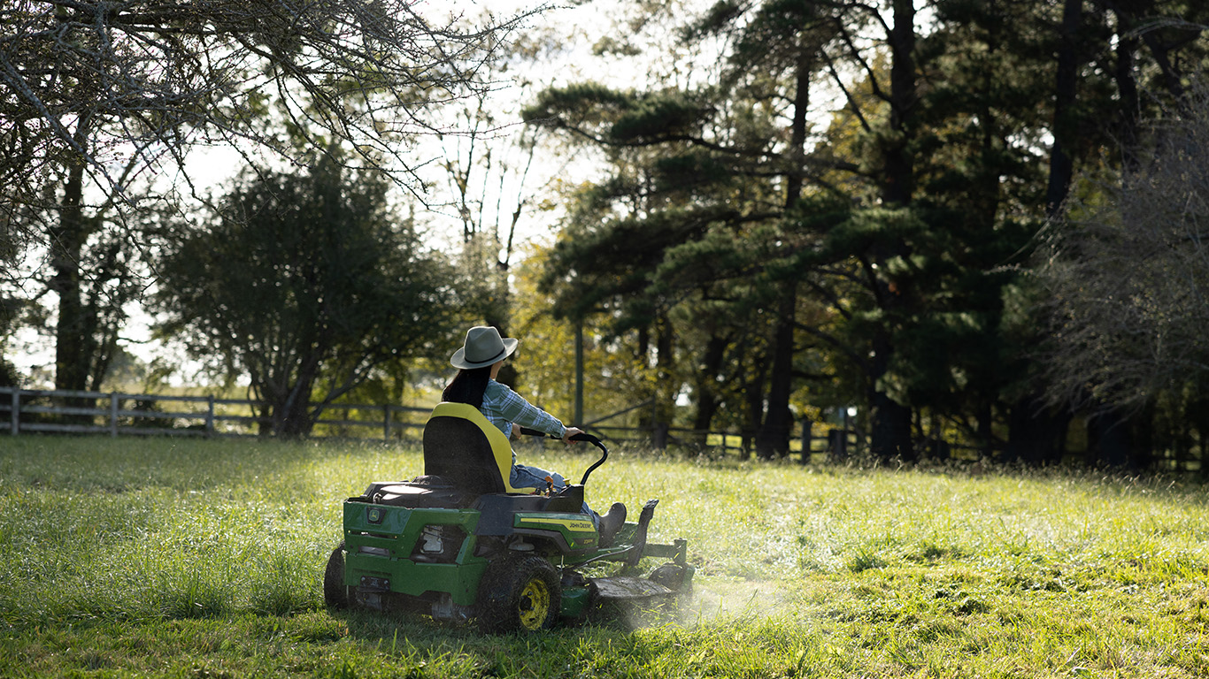 woman on a John Deere residential ztrak zero turn mower