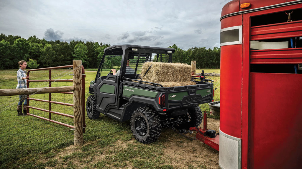 XUV 845M pulling hay and cattle trailer through fence XUV 845M pulling hay and cattle trailer through fence