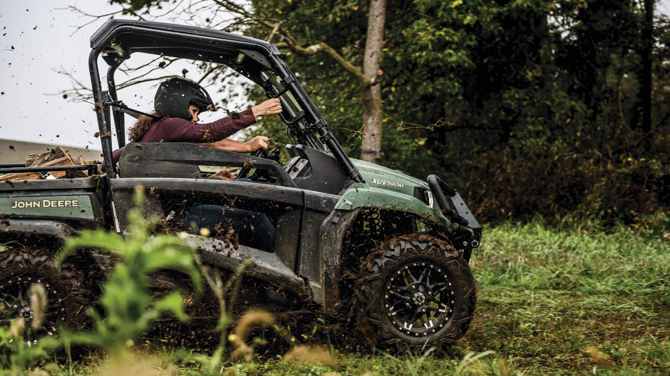 mid-size gator™ being driven on a dirt trail mid-size gator™ being driven on a dirt trail