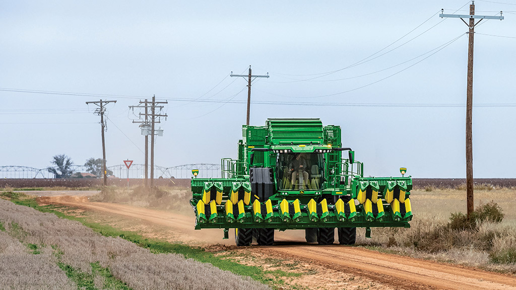 Image of a cotton harvester driving down a country road Image of a cotton harvester driving down a country road