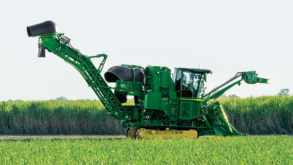 Wide photo showing a CH Series Sugar Harvester at work in a sugar cane field. Wide photo showing a CH Series Sugar Harvester at work in a sugar cane field.