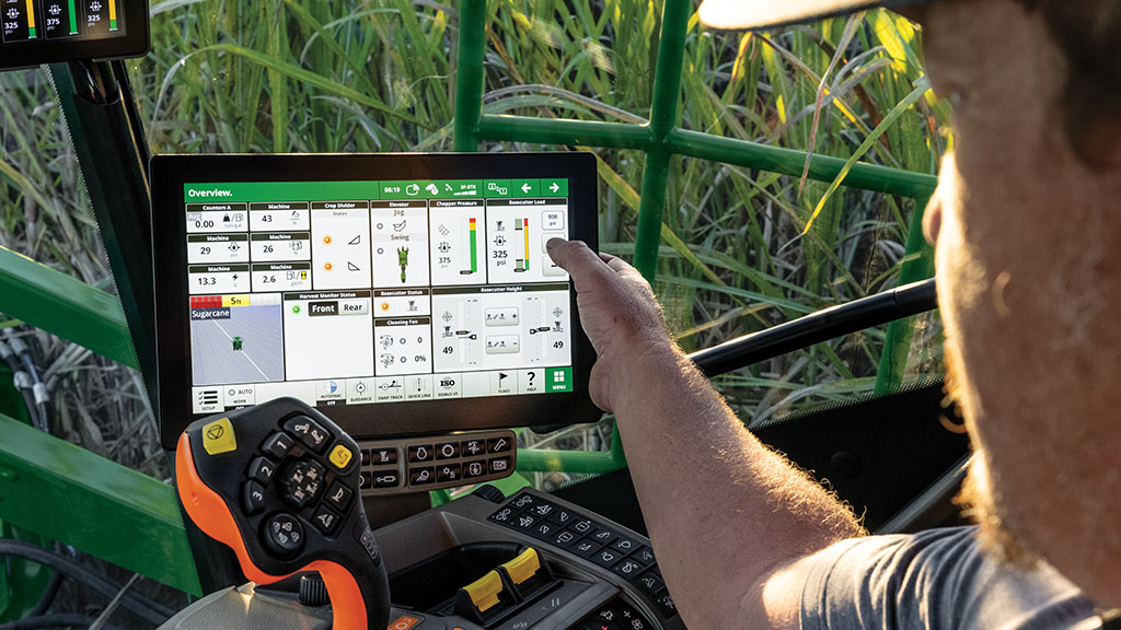 Close-up, in-cab photo showing a farmer interacting with his G5 Display in a CH Series Sugar Harvester. Close-up, in-cab photo showing a farmer interacting with his G5 Display in a CH Series Sugar Harvester.