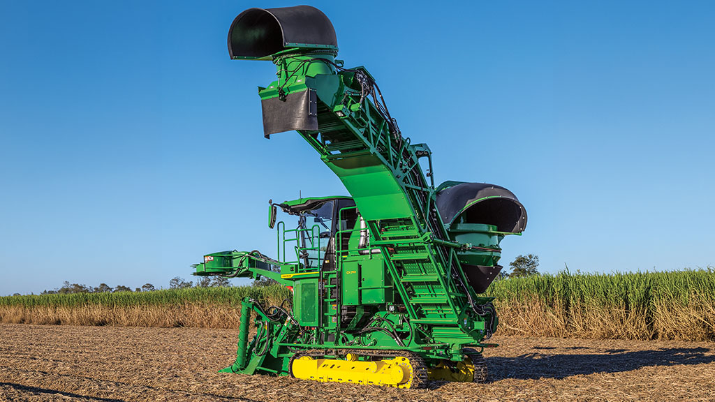 Rear-view photo showing a CH Series Sugar Harvester with elevated elevator in a sugar cane field. Rear-view photo showing a CH Series Sugar Harvester with elevated elevator in a sugar cane field.