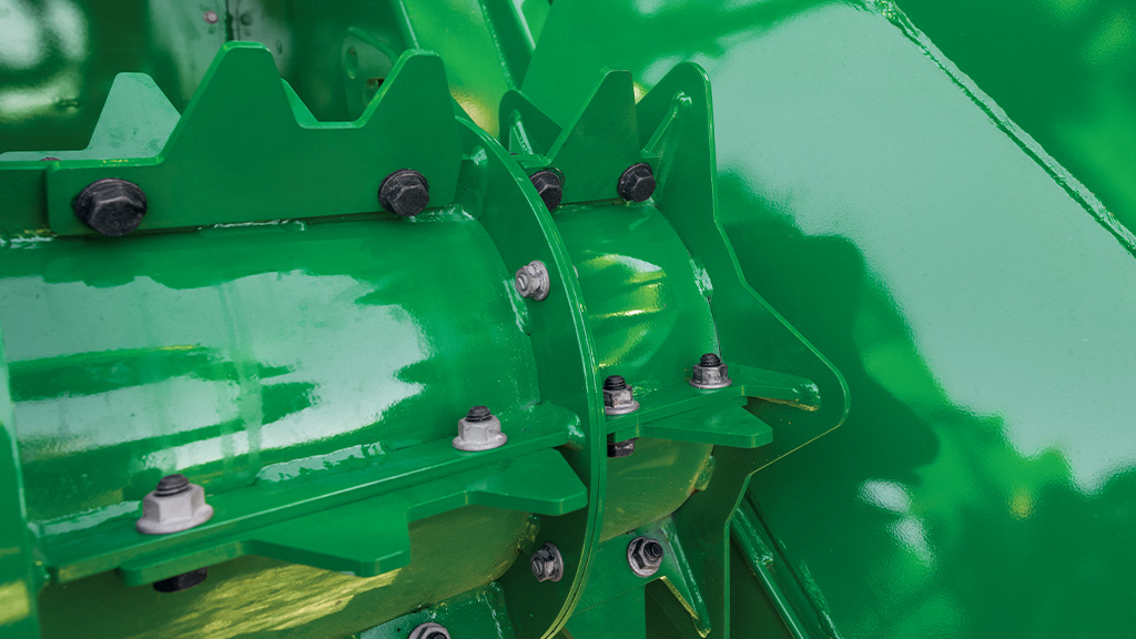 A close-up photo showing the scalloped knockdown roller end caps on a CH Series Sugar Harvester. A close-up photo showing the scalloped knockdown roller end caps on a CH Series Sugar Harvester.