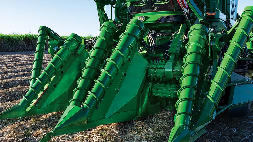 Photo showing the heavy-feeding front end of a CH Series Sugar Harvester in a field. Photo showing the heavy-feeding front end of a CH Series Sugar Harvester in a field.