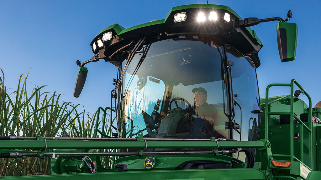 Photo looking up at the front of a cab showing an operator in a CH Series Sugar Harvester. Photo looking up at the front of a cab showing an operator in a CH Series Sugar Harvester.