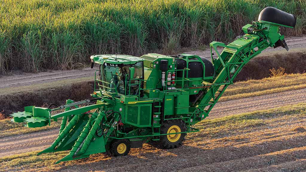 Wide photo showing a CH Series Sugar Harvester in a partially-harvested field. Wide photo showing a CH Series Sugar Harvester in a partially-harvested field.