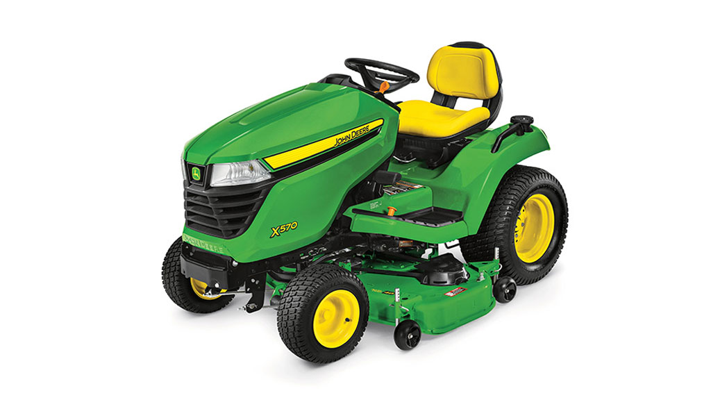 Green John Deere X570 lawn tractor with yellow seat and wheels.