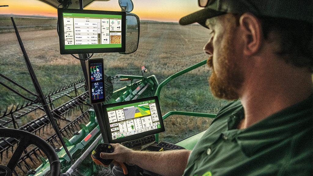 Grains producer in a John Deere Header utilising John Deere Work Planner to assist with planning a grains harvest.