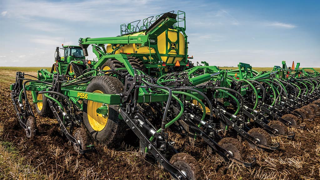 John Deere C650 Air Cart with a P556 Air Hoe Drill seeding small grain in a paddock