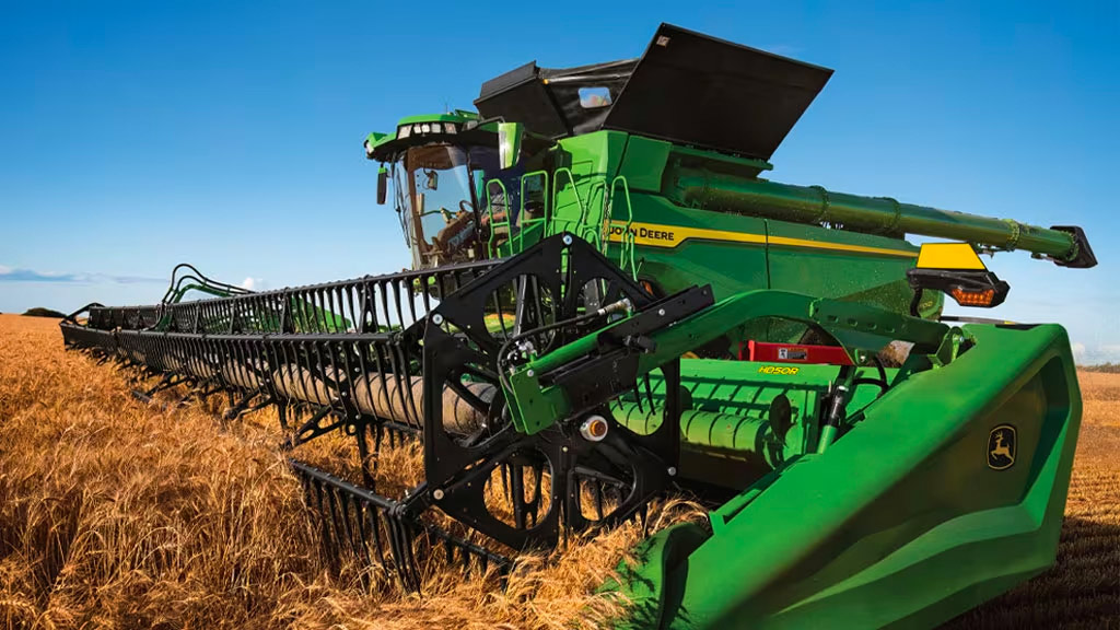 John Deere X9 Combine Harvester with Draper harvesting a wheat field