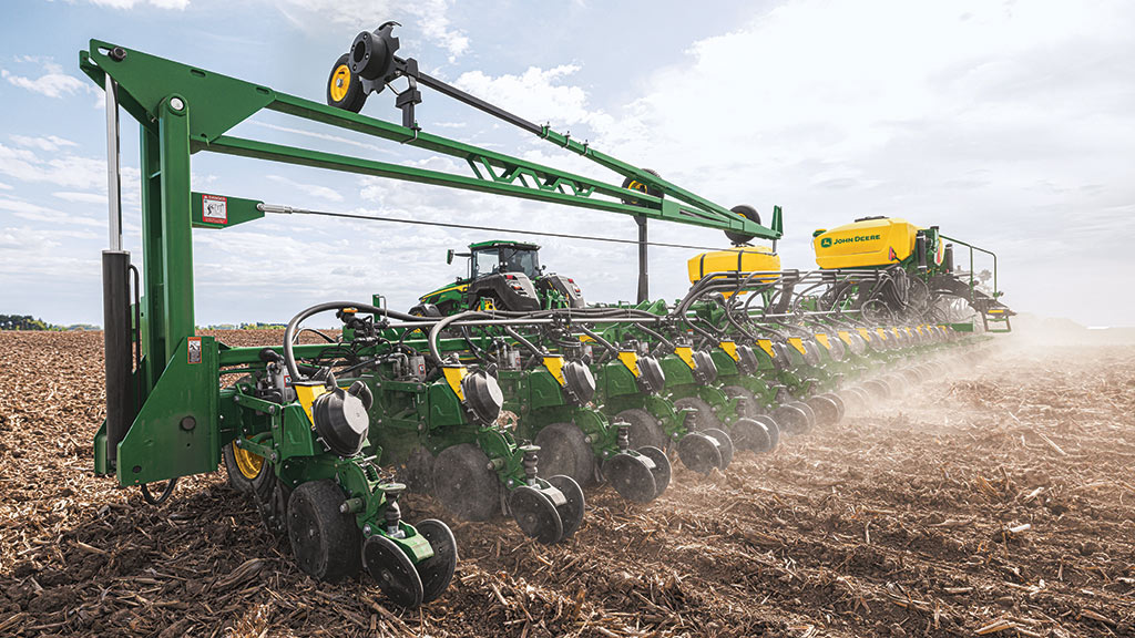 High-horsepower 8R Tractor planting in a field.