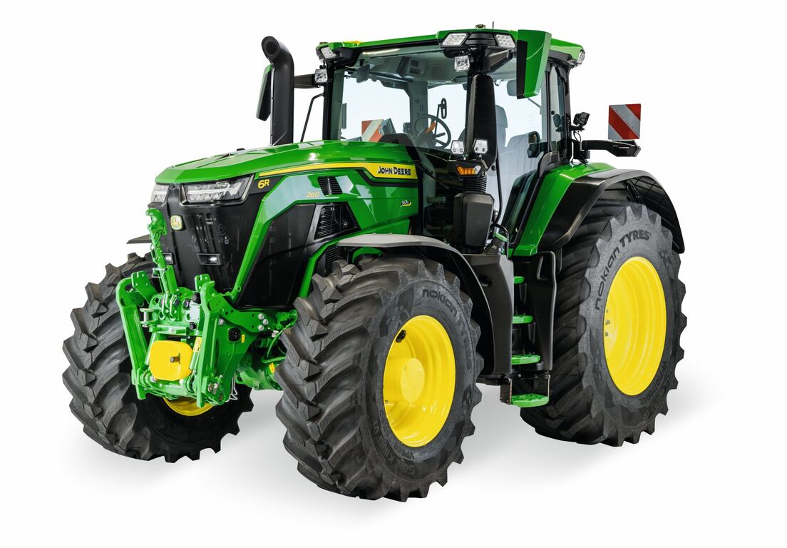 John Deere 6R tractor with enclosed cab and large agricultural tires, shown in a studio view for modern farming operations