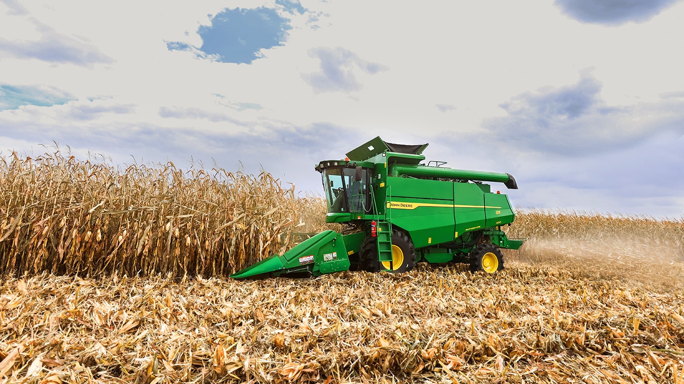 combine harvester with wide grain header on a white background, showing full machine design