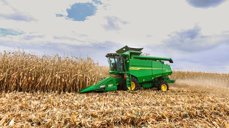 combine harvester with wide grain header on a white background, showing full machine design