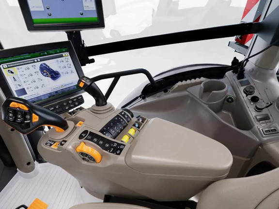 John Deere tractor cab interior with CommandARM controls and touchscreen display showing machine settings.