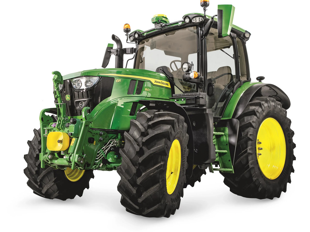 Green John Deere agricultural tractor with deep‑tread tires, front hitch, and cab lighting on a white background.